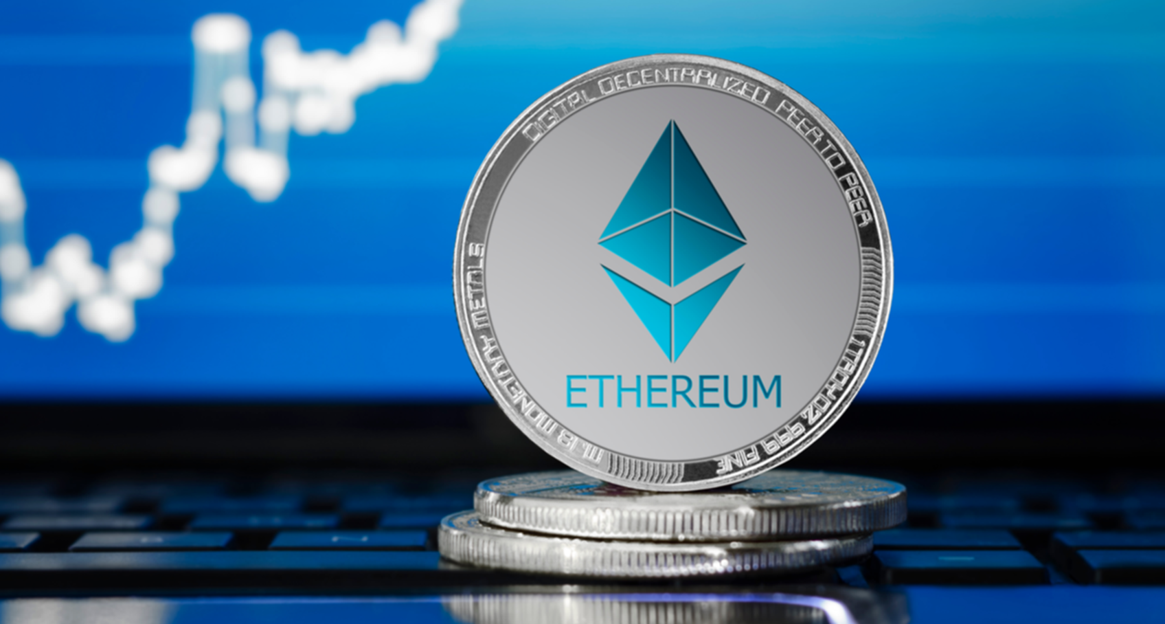 A physical ethereum crypto coin featuring the ethereum logo sits against a blue background